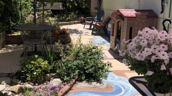 Tucker Backyard after renovation with tiling, plants and painted pathway