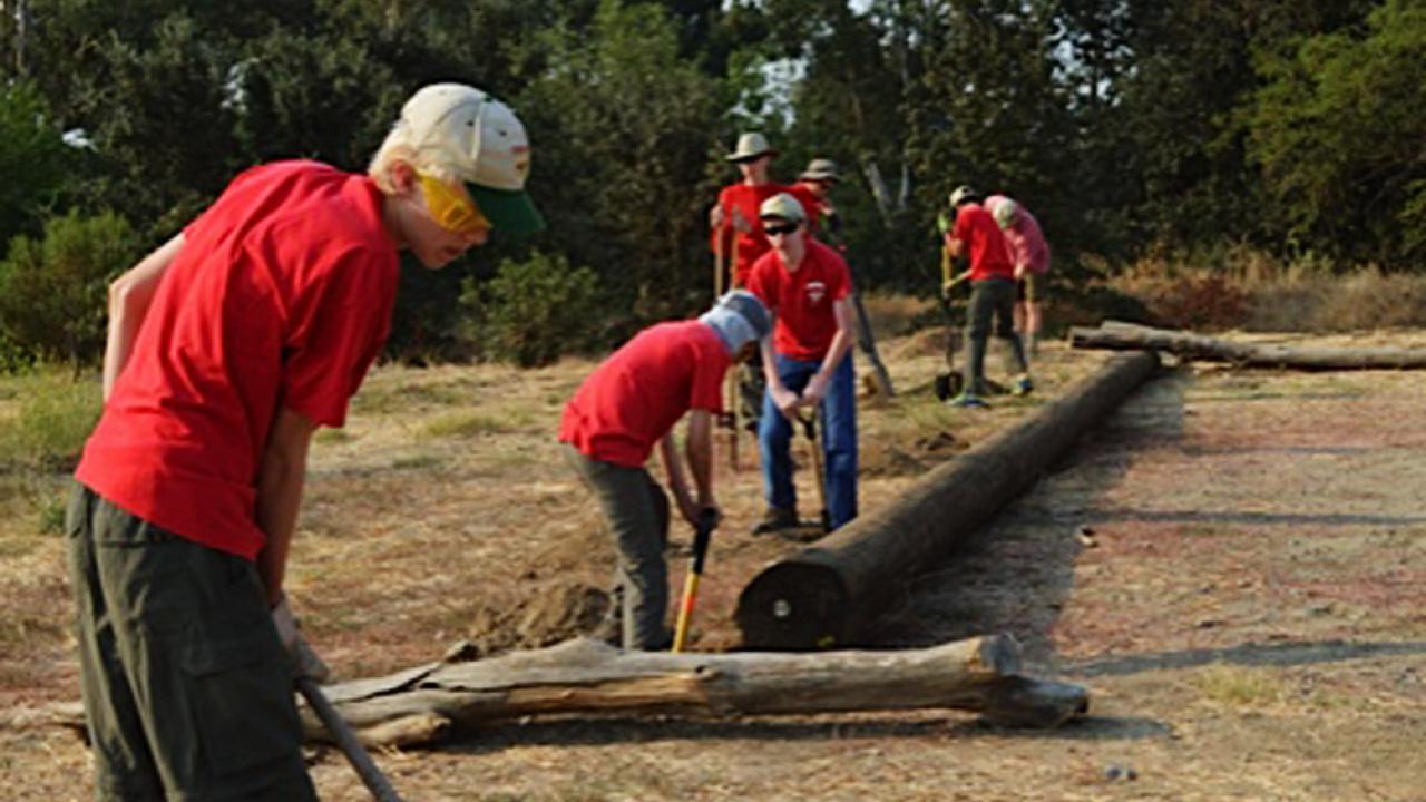 Lucas Needles, foreground, and other Scouts from Troop 111, work on Eagle Scout Garrett Dawson’s project to help protect the sensitive landscape at UC Davis Putah Creek Riparian Reserve. Scouts from Troop 111 work to install posts along the reserve to protect the sensitive landscape at UC Davis Putah Creek Riparian Reserve.