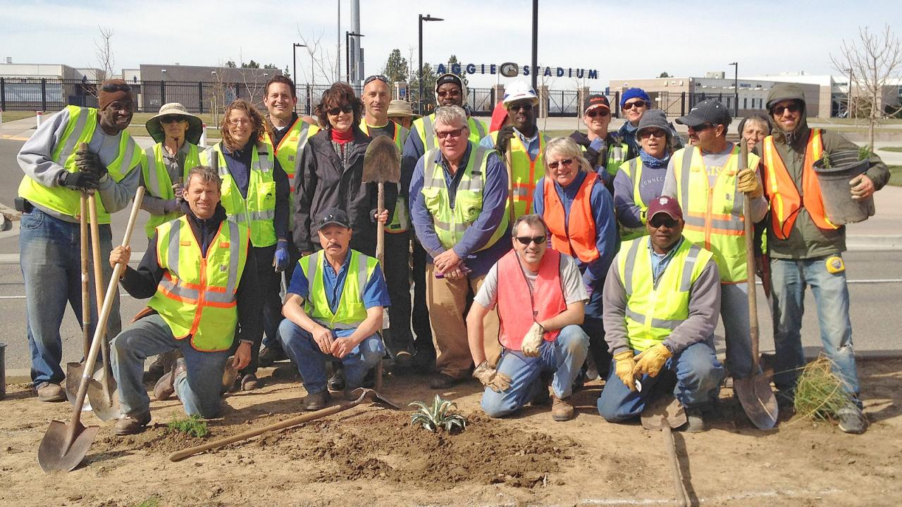 Arboretum and Public Garden staff, including Kathleen Socolofsky, assistant vice chancellor and director of the Arboretum, stand in front of Aggie Stadium.