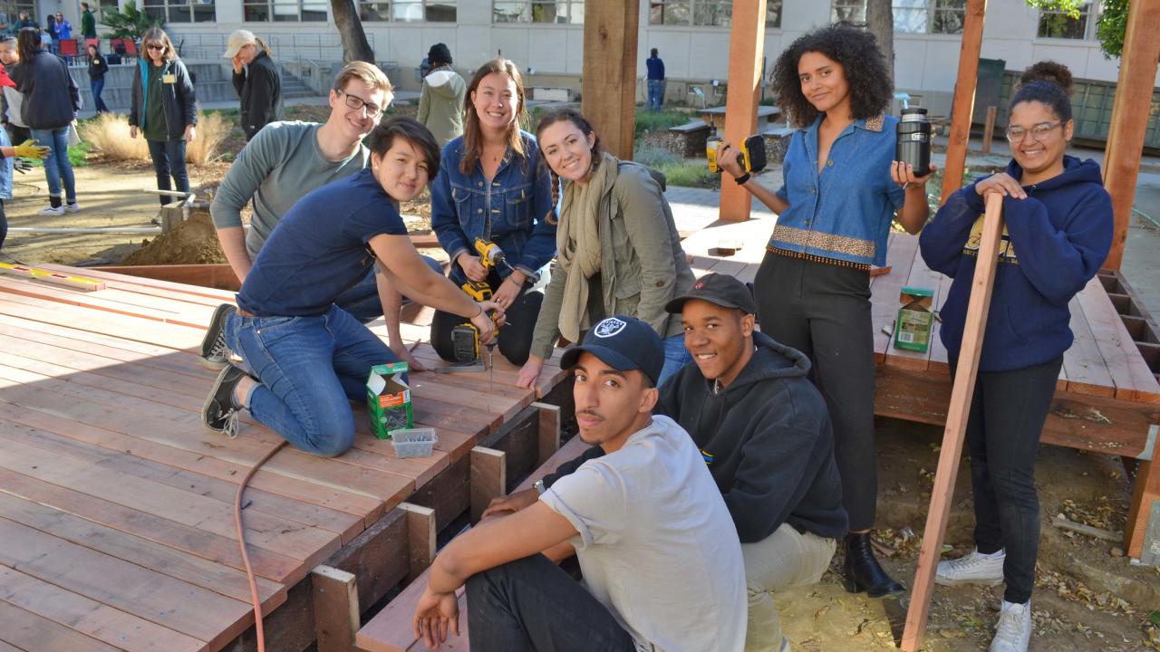 Group of students pose in Hunt Hall courtyard
