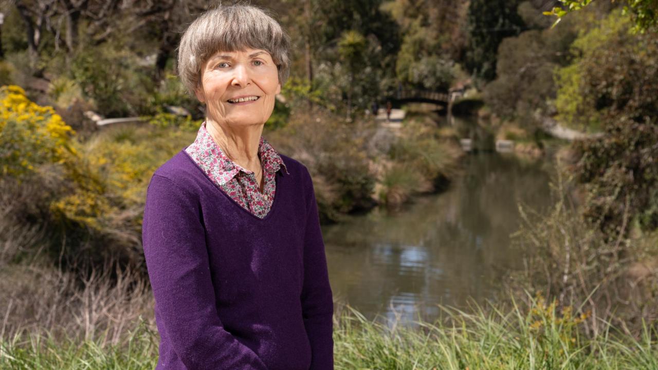 Karen Slinkard posing in front of the Arboretum Waterway