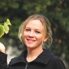 Kathy Guertze poses with a Gingko tree